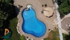 Aerial Drone Shot Of Pool At Back Of House